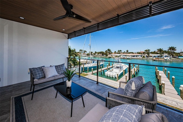 balcony featuring a water view, an outdoor living space, ceiling fan, and a dock