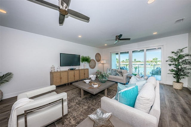 living room with dark hardwood / wood-style flooring and ceiling fan