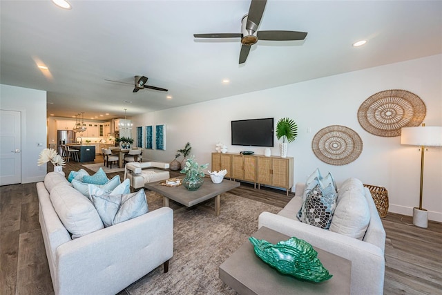 living room with dark wood-type flooring and ceiling fan