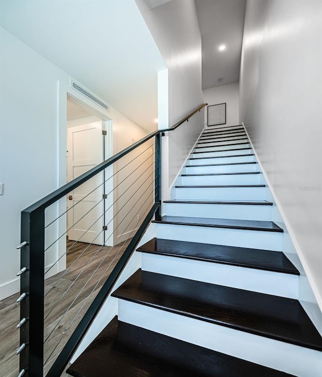 staircase featuring dark wood-type flooring