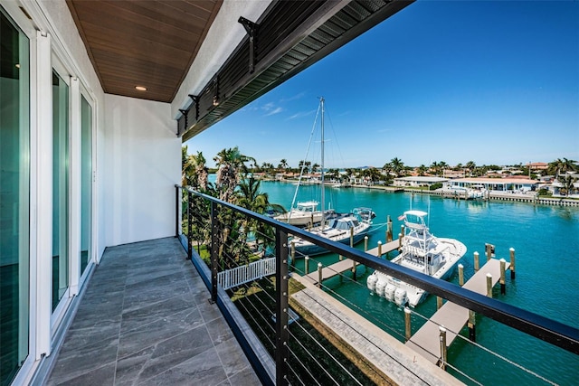 balcony featuring a water view and a boat dock