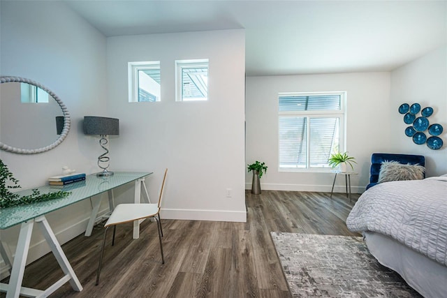 bedroom with dark hardwood / wood-style flooring