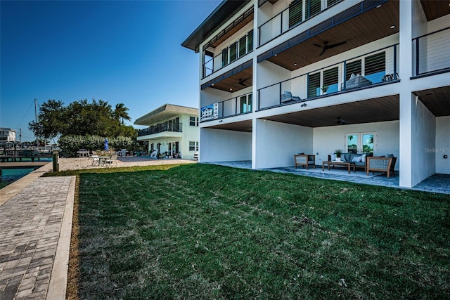 exterior space featuring a patio, a balcony, an outdoor hangout area, and a lawn