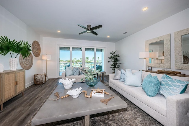 living room featuring dark hardwood / wood-style flooring and ceiling fan