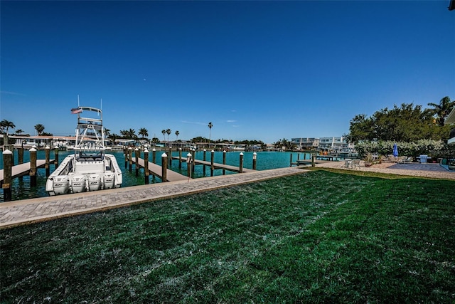 dock area with a water view and a lawn