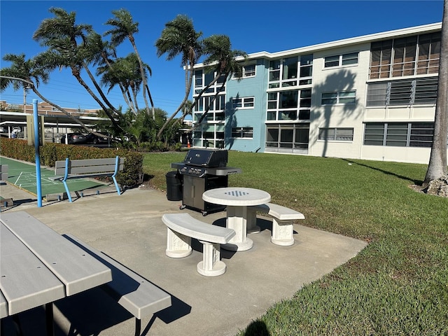 view of home's community with a patio area and a lawn