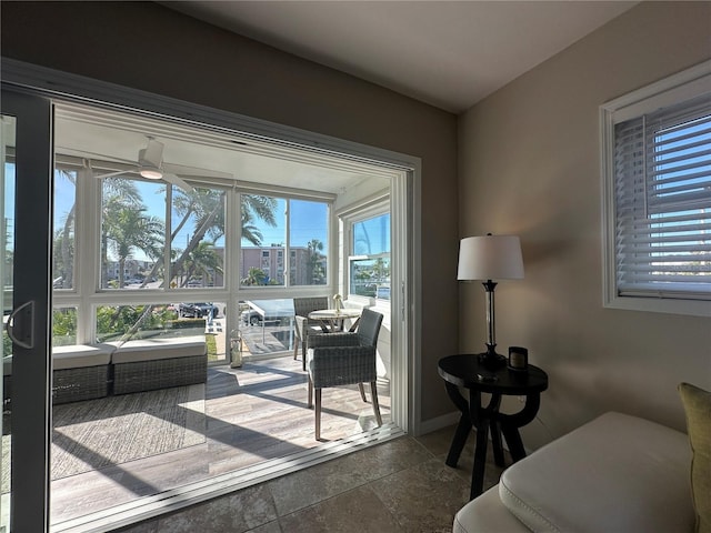 sunroom / solarium featuring ceiling fan