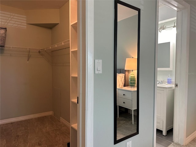 spacious closet featuring sink