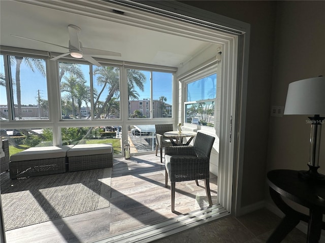 sunroom / solarium featuring ceiling fan