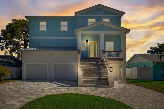 view of front of house featuring a garage and a porch