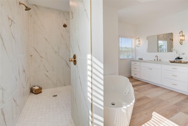 bathroom featuring vanity, hardwood / wood-style flooring, and plus walk in shower