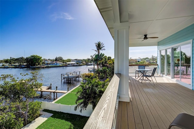 wooden terrace featuring a water view and ceiling fan