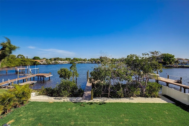 dock area with a water view and a lawn