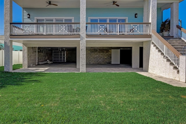 rear view of property featuring a patio, ceiling fan, and a lawn