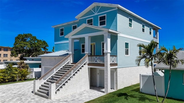 view of front of house featuring a porch and a garage