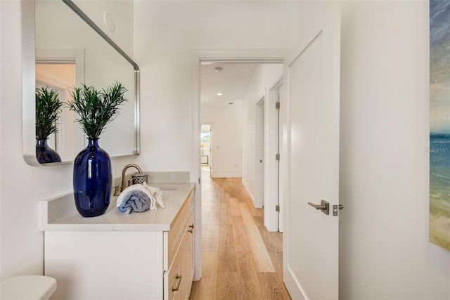 hall featuring sink and light wood-type flooring