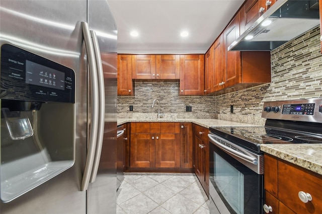 kitchen featuring appliances with stainless steel finishes, light stone countertops, light tile patterned flooring, ventilation hood, and decorative backsplash