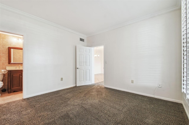 unfurnished bedroom with sink, crown molding, ensuite bath, and carpet flooring