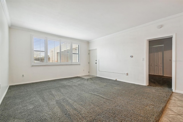 spare room with ornamental molding and tile patterned flooring