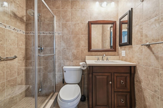 bathroom featuring vanity, toilet, and a shower with door