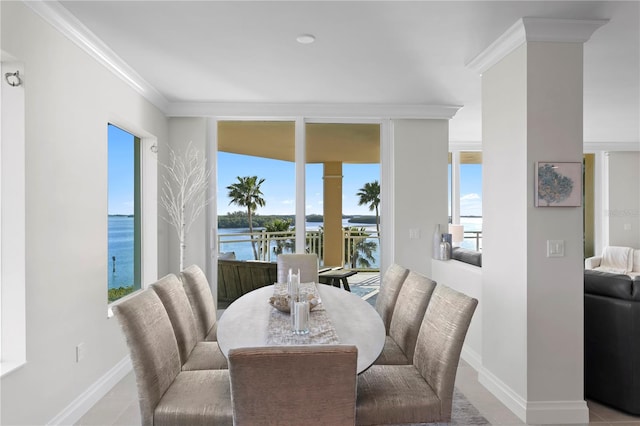 dining area with crown molding, a water view, light tile flooring, and a healthy amount of sunlight