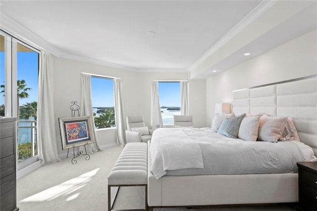 carpeted bedroom featuring crown molding, a water view, and multiple windows