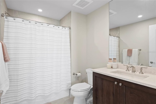 bathroom featuring tile flooring, vanity with extensive cabinet space, and toilet