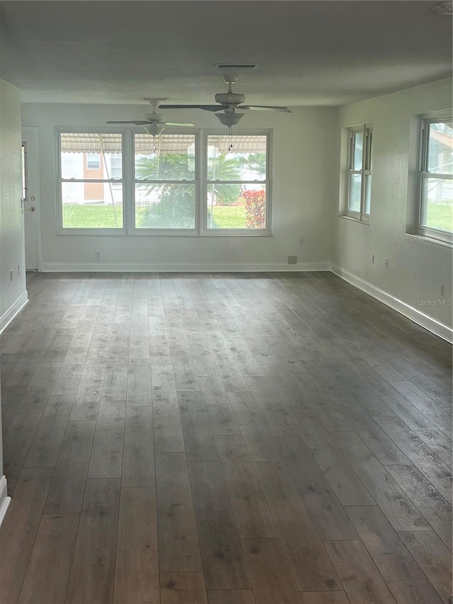 unfurnished room with ceiling fan and dark hardwood / wood-style flooring