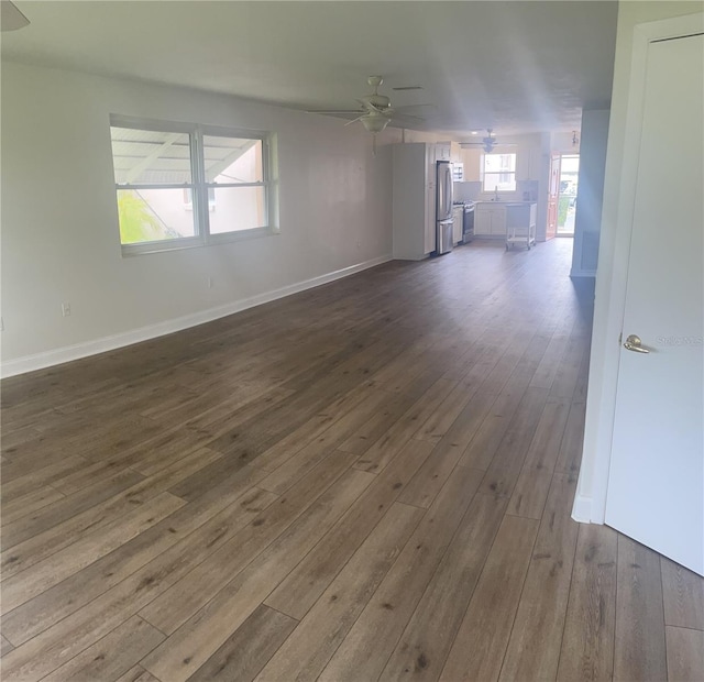 unfurnished room featuring ceiling fan and dark wood-type flooring