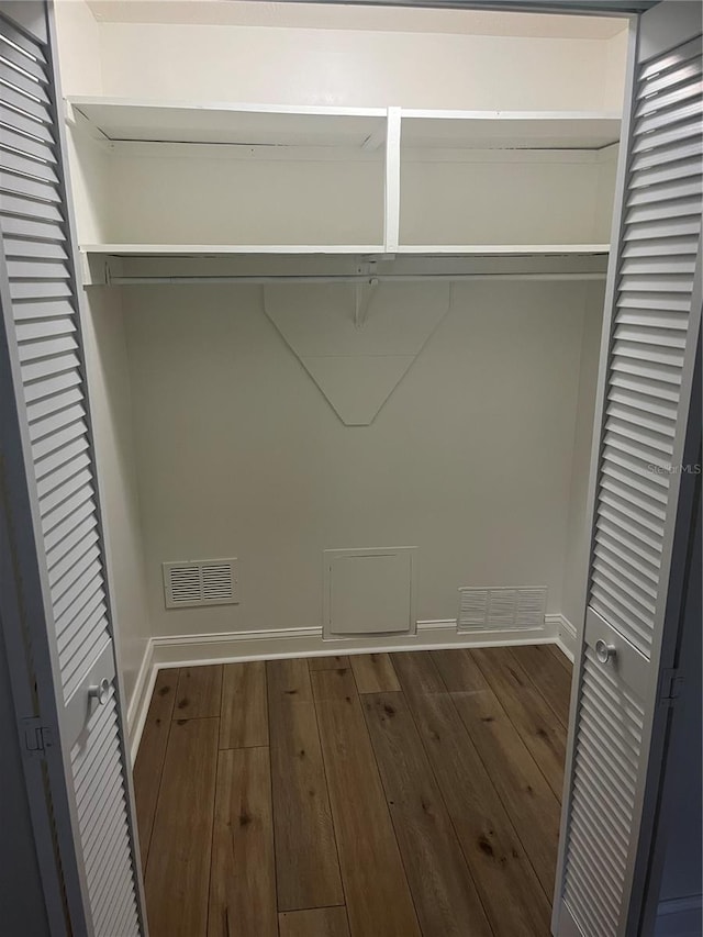 clothes washing area featuring dark wood-type flooring