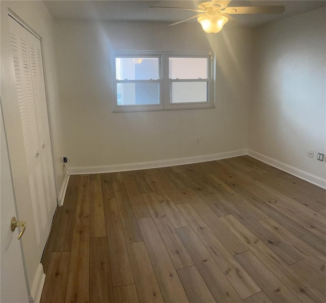 interior space with a closet, ceiling fan, and dark hardwood / wood-style flooring