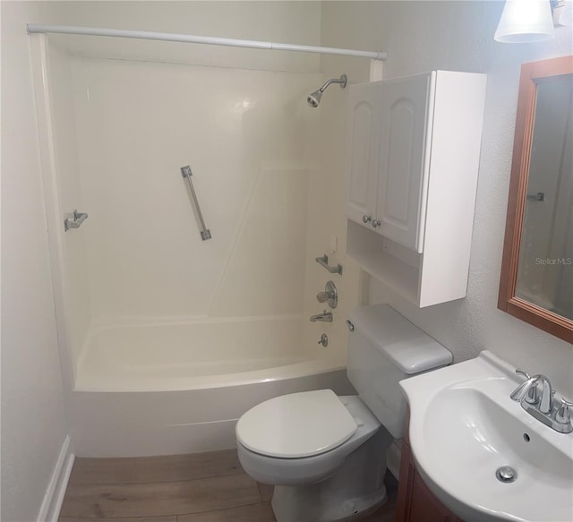 full bathroom featuring shower / tub combination, toilet, hardwood / wood-style floors, and oversized vanity