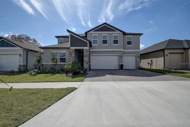 view of front of property featuring a front lawn and a garage