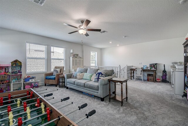 living room with light colored carpet, a textured ceiling, and ceiling fan