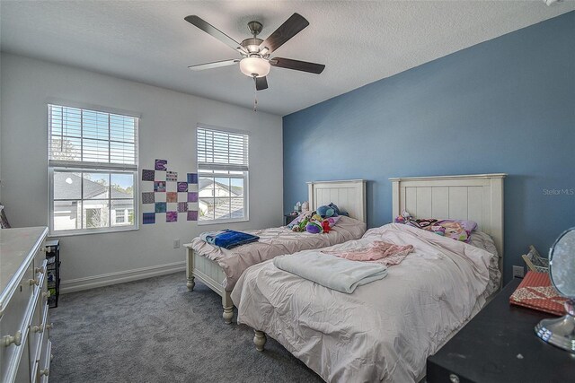 carpeted bedroom featuring a textured ceiling and ceiling fan