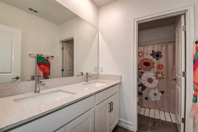 bathroom featuring large vanity and double sink