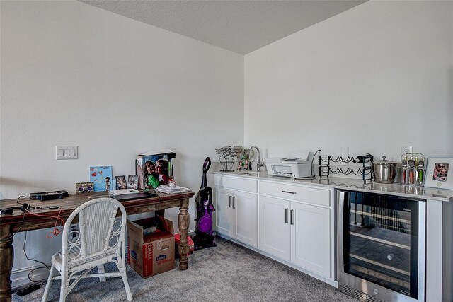 office area with light colored carpet and beverage cooler