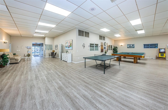 recreation room with wood finished floors, visible vents, and a paneled ceiling