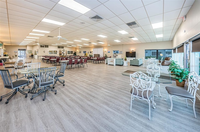 interior space with visible vents, a drop ceiling, and wood finished floors