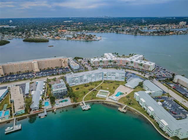 birds eye view of property featuring a view of city and a water view