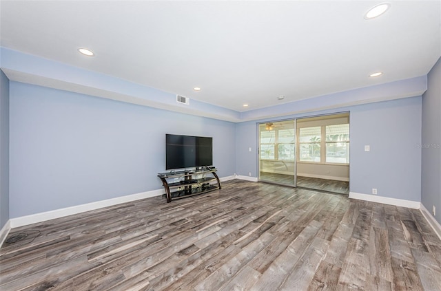 unfurnished living room featuring recessed lighting, visible vents, baseboards, and wood finished floors