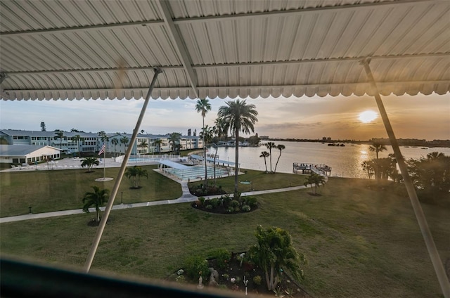 dock area with a water view and a lawn