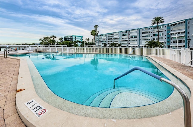 community pool featuring a patio and fence