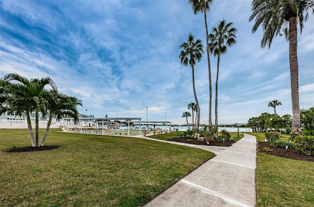 exterior space featuring a lawn and a water view