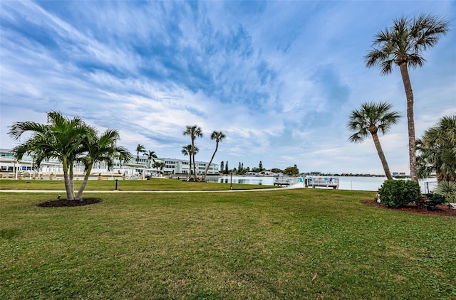 view of home's community with a lawn and a water view