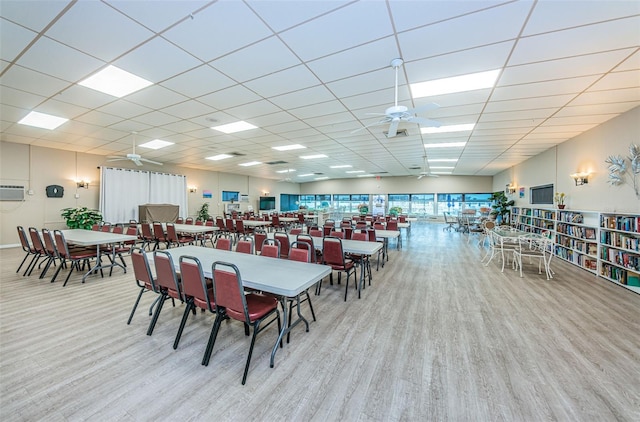 dining room with a paneled ceiling, a ceiling fan, and wood finished floors