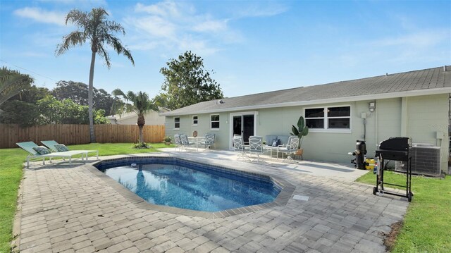 view of pool featuring a patio and a yard