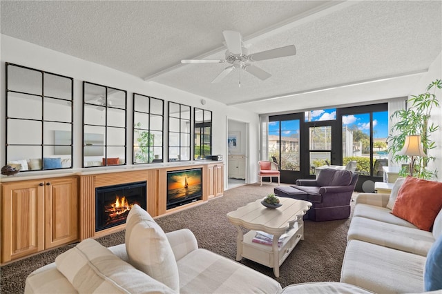 living room featuring a textured ceiling, ceiling fan, and dark colored carpet