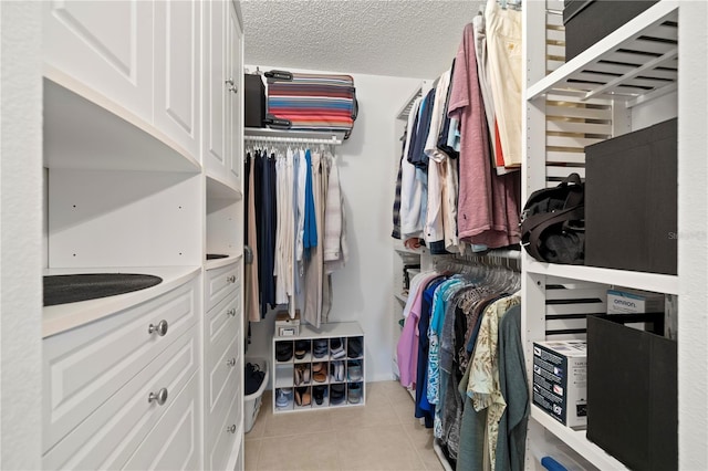 walk in closet featuring light tile flooring