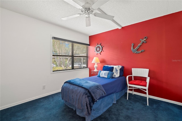 carpeted bedroom featuring a textured ceiling and ceiling fan